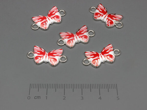 Пеперуда в бяло и червено 23x12mm, отвор халки 2.4mm - 10 бр.