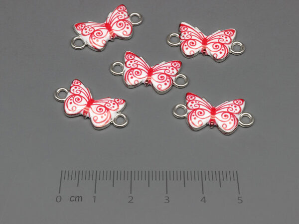 Пеперуда в бяло и червено 23x12mm, отвор халки 2.4mm - 10 бр.