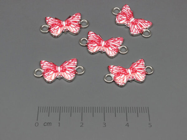 Пеперуда в бяло и червено 23x12mm, отвор халки 2.4mm - 10 бр.