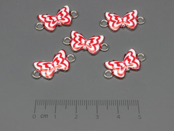 Пеперуда в бяло и червено 23x12mm, отвор халки 2.4mm - 10 бр.